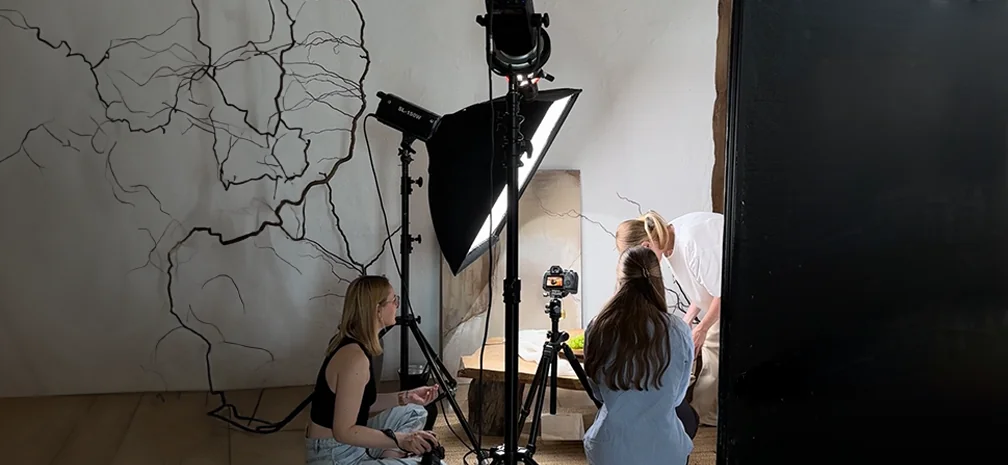 Behind-the-scenes photo shoot creating crafted content for social media with lighting and camera equipment.