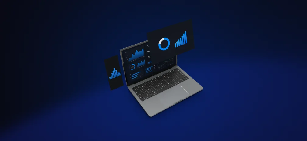Laptop displaying digital analytics charts and graphs on a dark blue background.